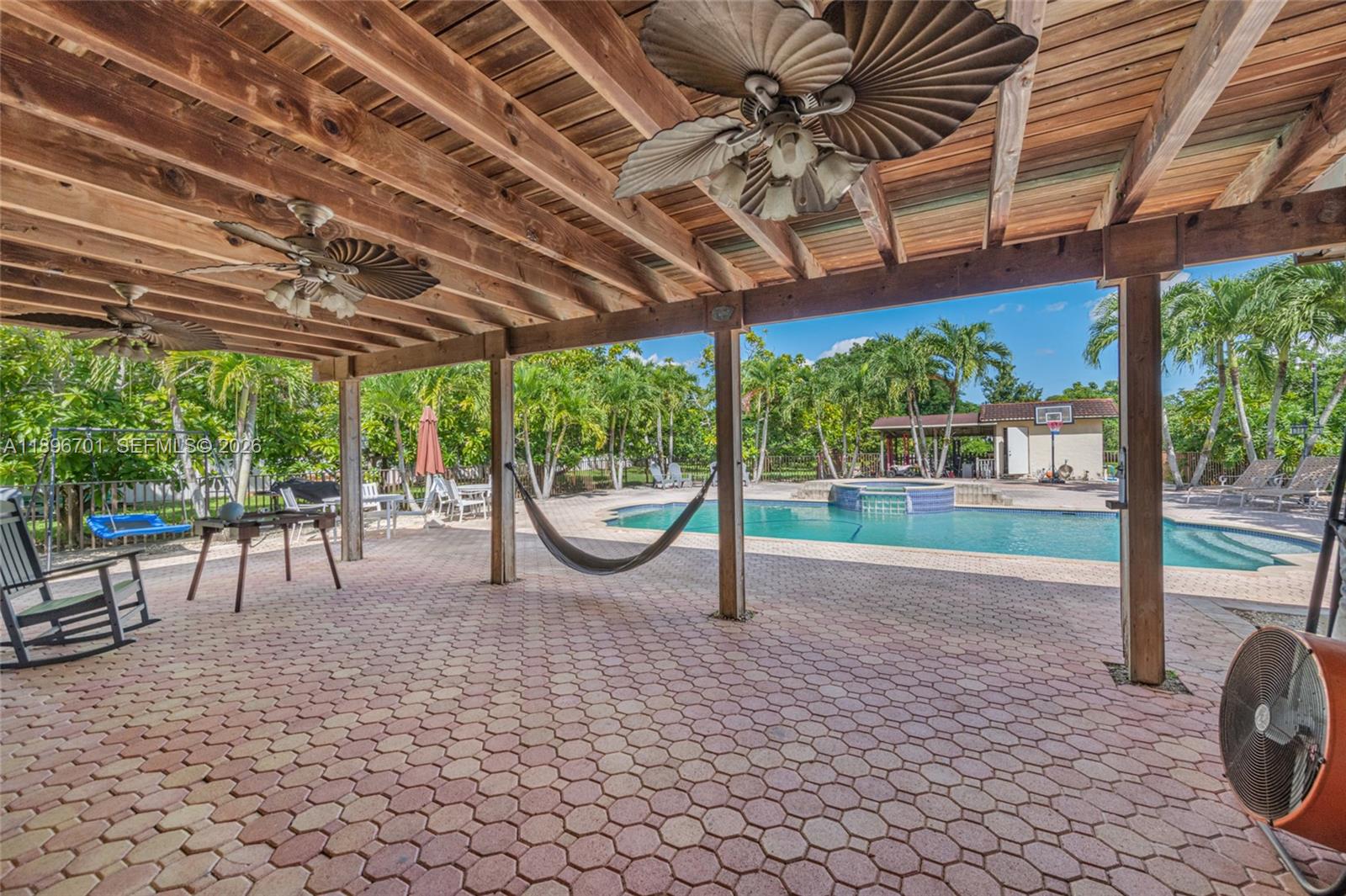 19491 Southwest 216th Street Miami, FL 33187 - Photo 26 of 32 a view of a porch with a table and chairs