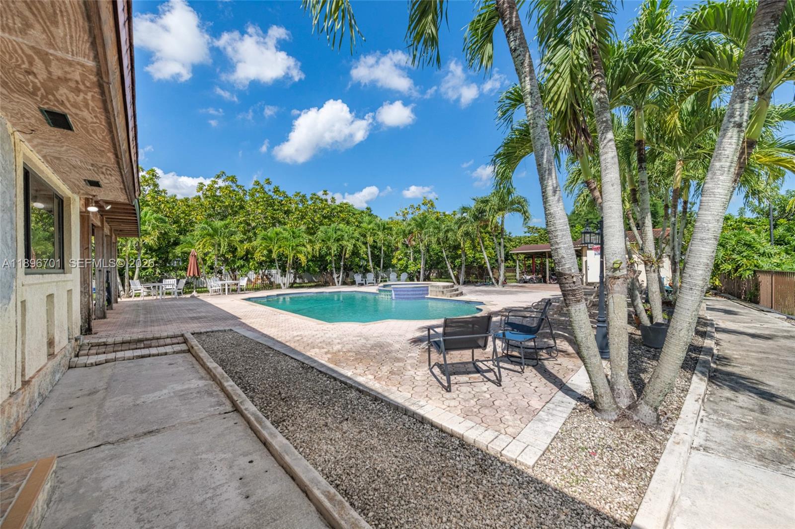 19491 Southwest 216th Street Miami, FL 33187 - Photo 28 of 32 a swimming pool with outdoor seating and yard