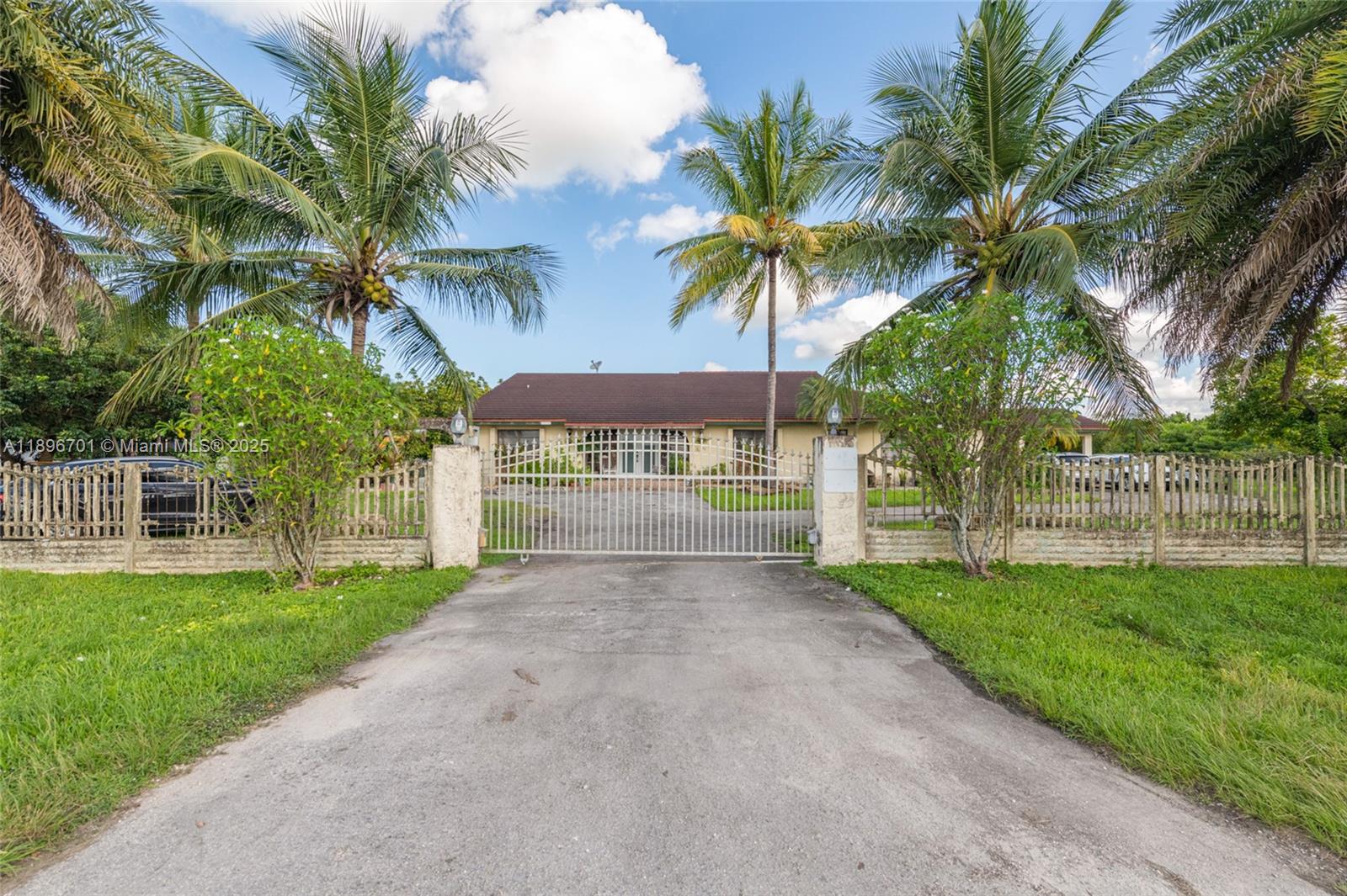 19491 Southwest 216th Street Miami, FL 33187 - Photo 3 of 37 a view of a yard with a palm trees