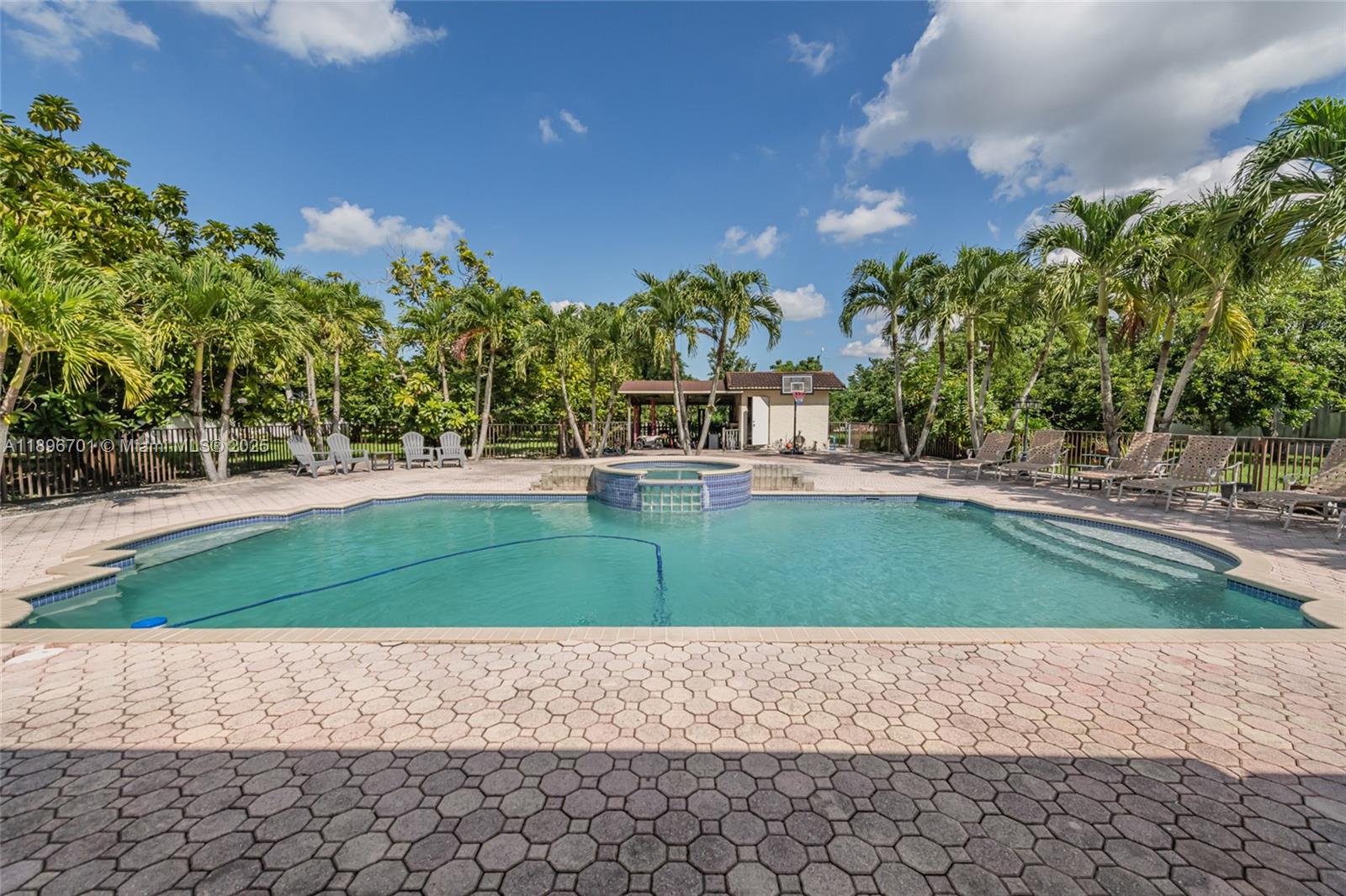 19491 Southwest 216th Street Miami, FL 33187 - Photo 31 of 37 a green field with trees in front of it