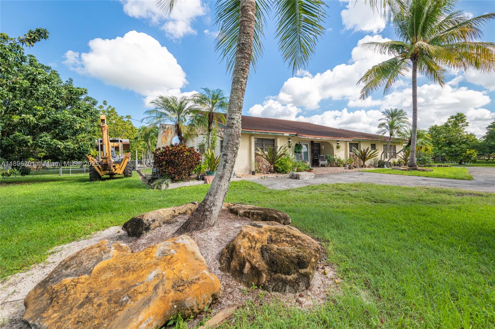 19491 Southwest 216th Street Miami, FL 33187 - Photo 4 of 37 a view of a yard and front view of a house