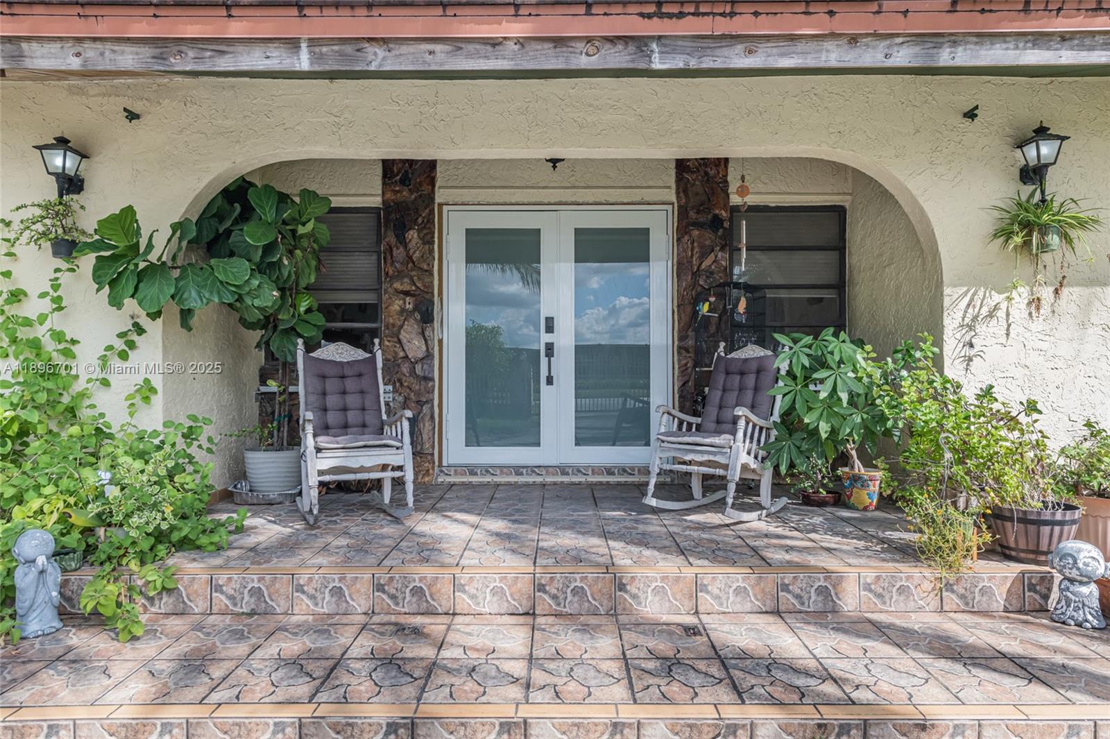 19491 Southwest 216th Street Miami, FL 33187 - Photo 5 of 37 a front view of a house with garden