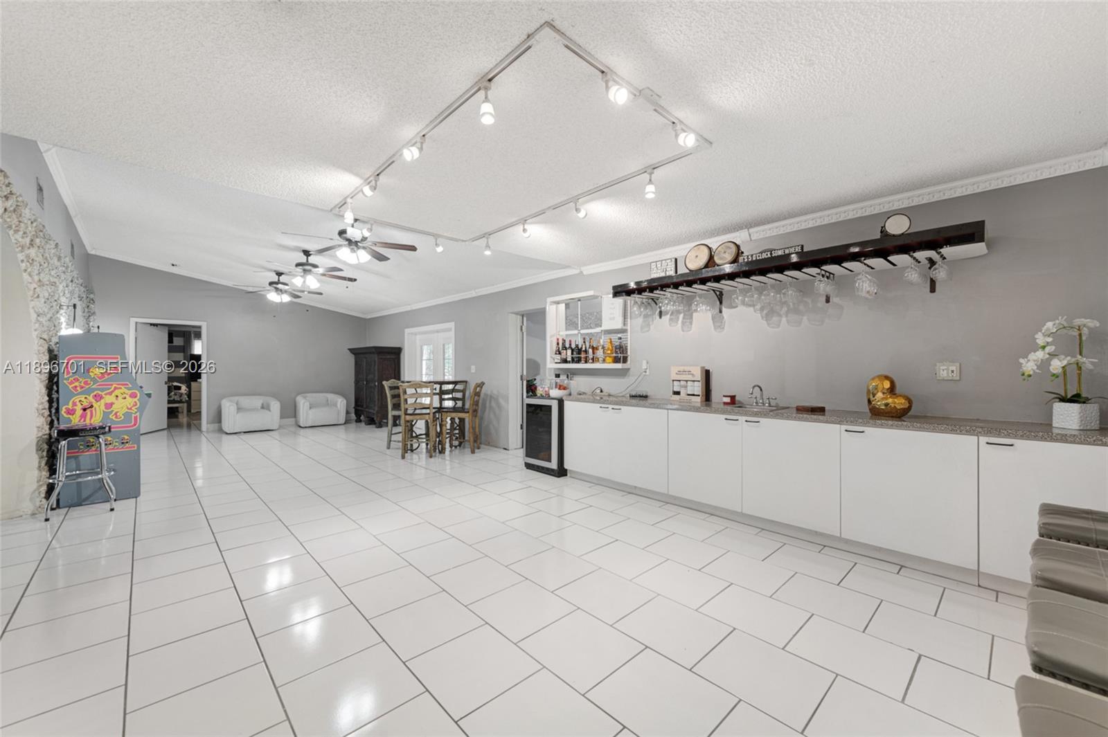 19491 Southwest 216th Street Miami, FL 33187 - Photo 10 of 32 a large white kitchen with cabinets and a chandelier