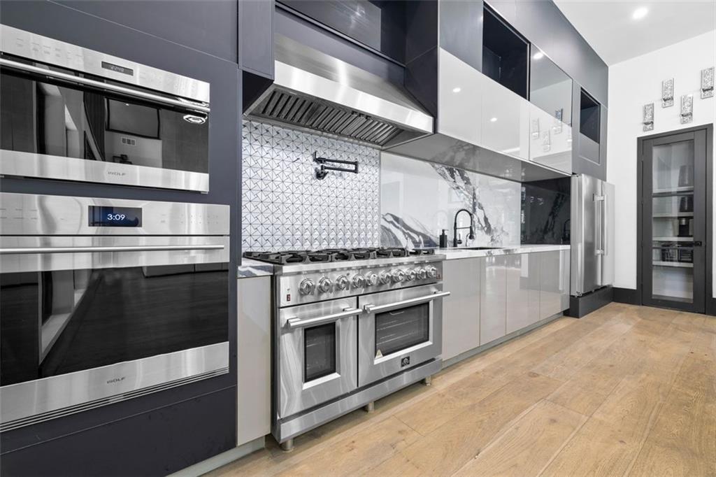 2401 Greenglade Road Northeast Atlanta, GA 30345 - Photo 18 of 64 a kitchen with stainless steel appliances and white cabinets