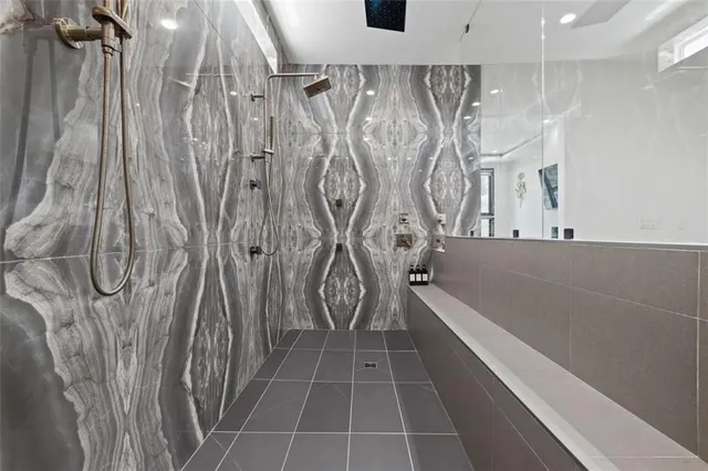 a spacious bedroom with a bed and a chandelier