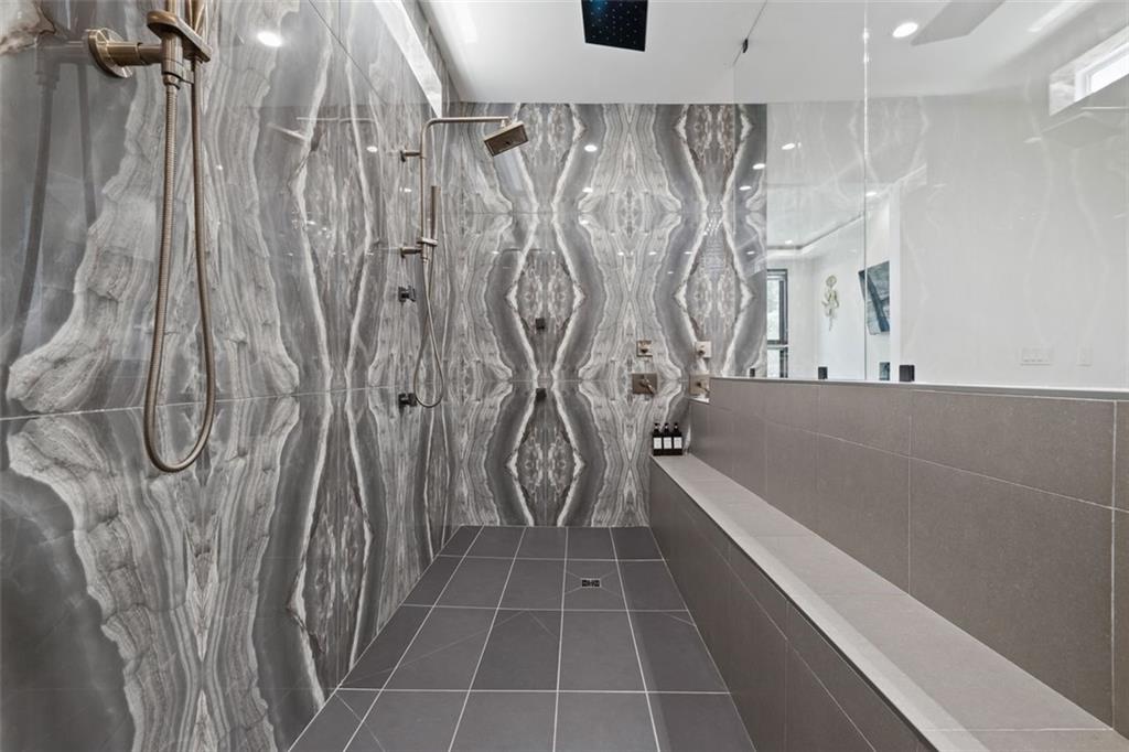 2401 Greenglade Road Northeast Atlanta, GA 30345 - Photo 28 of 64 a bathroom with a bathtub and a shower