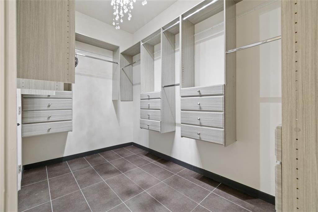2401 Greenglade Road Northeast Atlanta, GA 30345 - Photo 30 of 64 a view of walk in closet with empty racks
