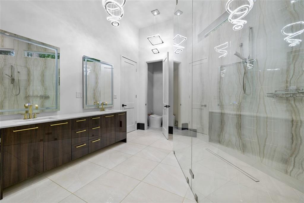 2401 Greenglade Road Northeast Atlanta, GA 30345 - Photo 37 of 64 a spacious bathroom with a double vanity sink mirror and shower