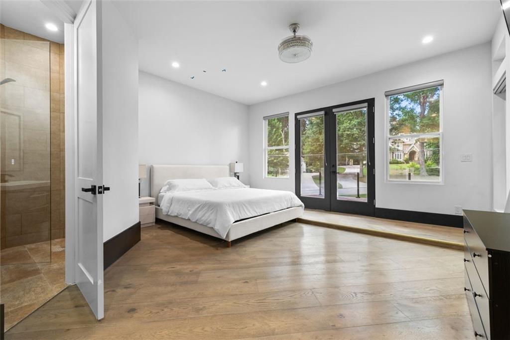 2401 Greenglade Road Northeast Atlanta, GA 30345 - Photo 42 of 64 a spacious bedroom with a bed and large windows