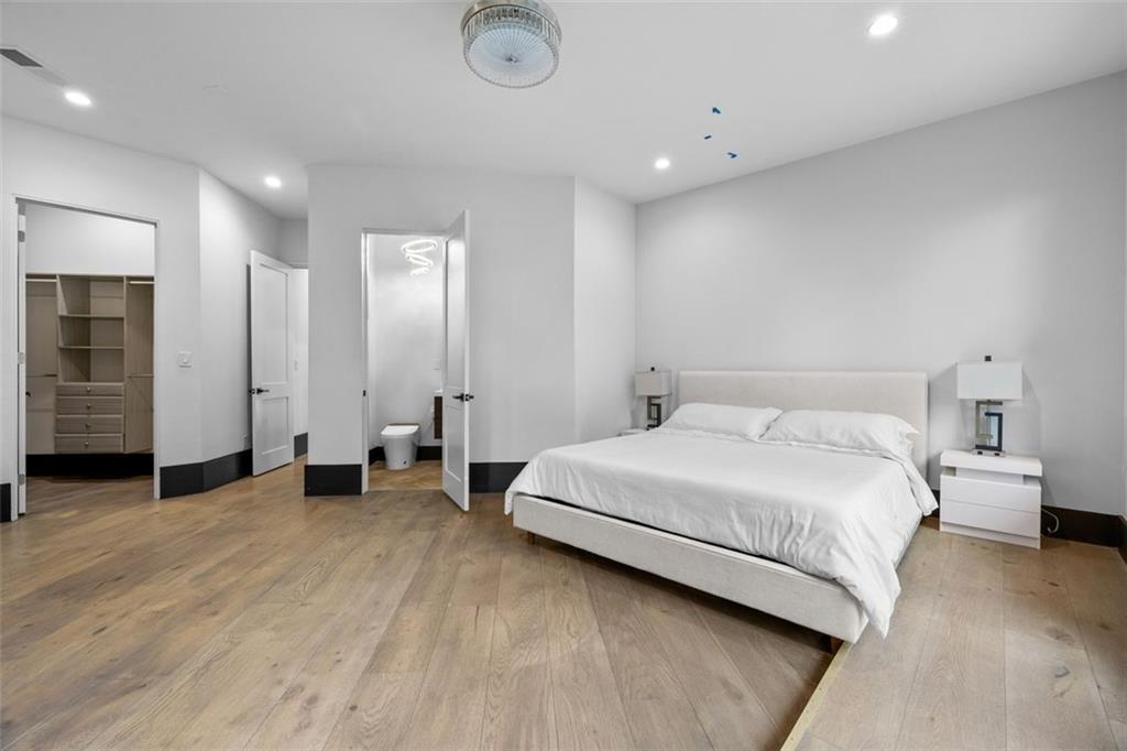 2401 Greenglade Road Northeast Atlanta, GA 30345 - Photo 43 of 64 a spacious bedroom with a bed and a table