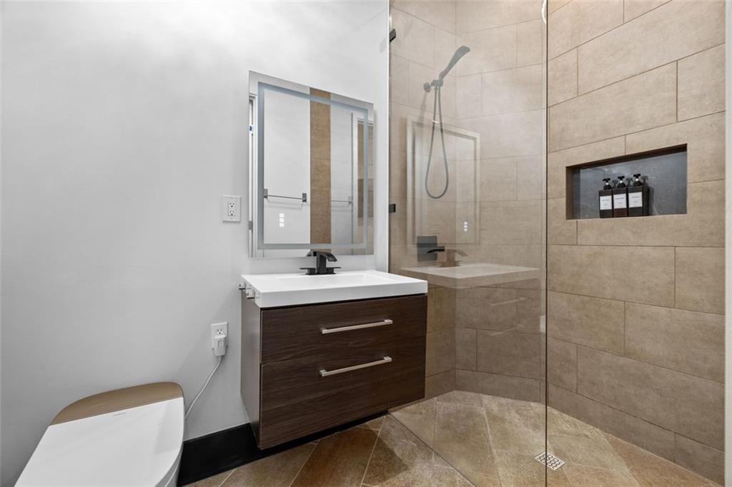 2401 Greenglade Road Northeast Atlanta, GA 30345 - Photo 44 of 64 a bathroom with a sink a toilet and shower