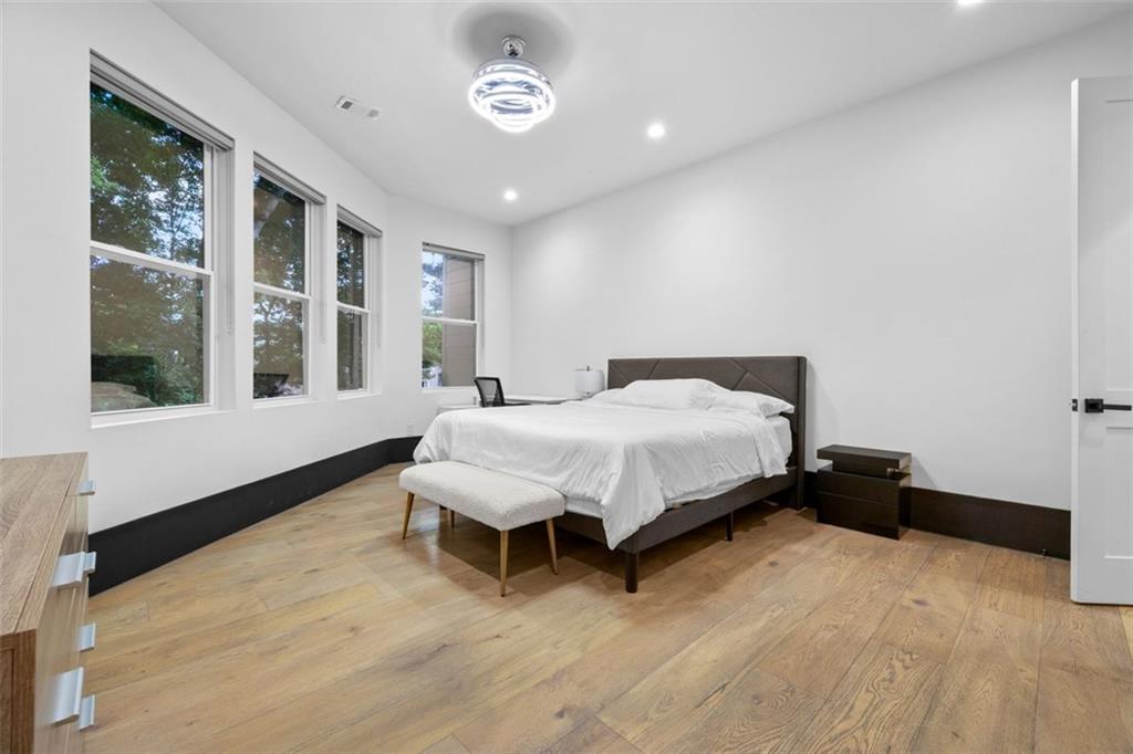 2401 Greenglade Road Northeast Atlanta, GA 30345 - Photo 45 of 64 a spacious bedroom with a bed and a large window