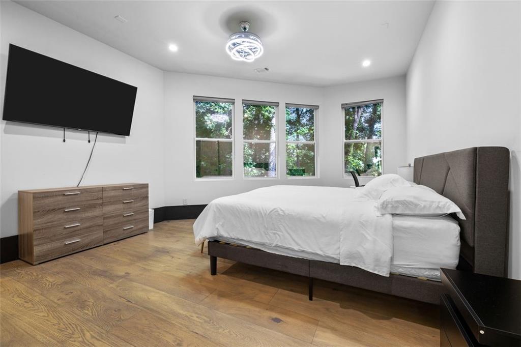 2401 Greenglade Road Northeast Atlanta, GA 30345 - Photo 46 of 64 a bedroom with a bed and a flat screen tv