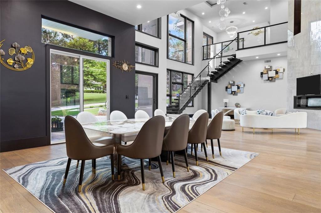 2401 Greenglade Road Northeast Atlanta, GA 30345 - Photo 5 of 64 a view of a dining room with furniture a chandelier and wooden floor