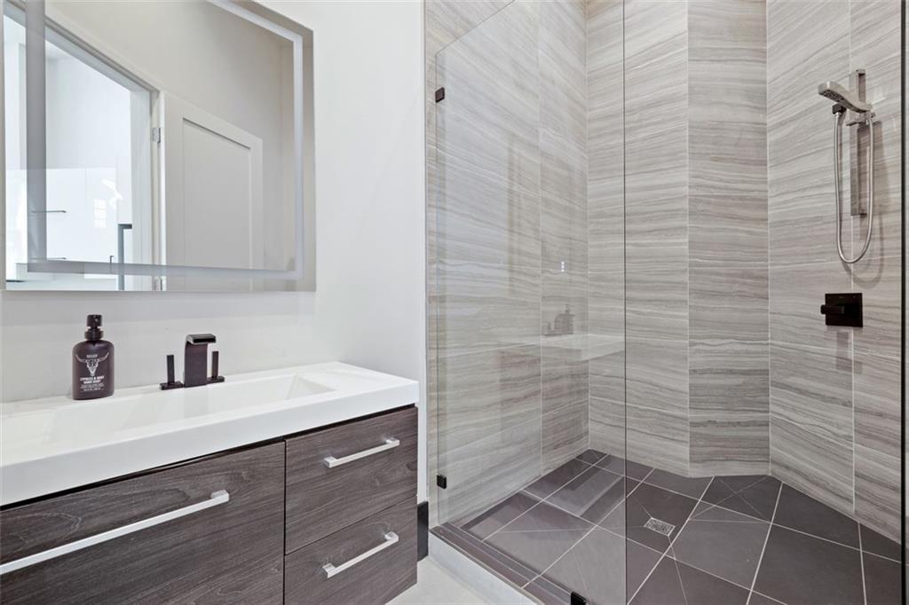 2401 Greenglade Road Northeast Atlanta, GA 30345 - Photo 57 of 64 a bathroom with a sink a toilet and a mirror