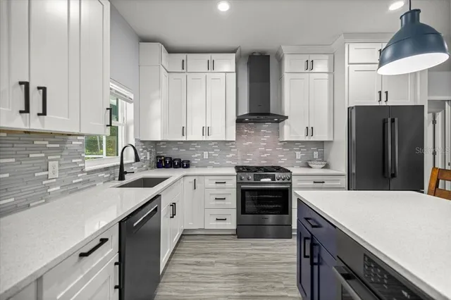 a kitchen with a sink stove and refrigerator