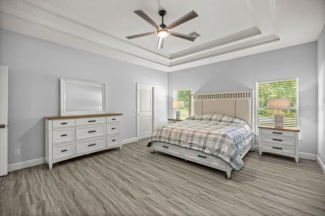 a bedroom with a bed and a flat tv screen on dresser