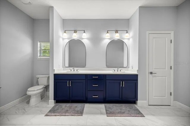 a bathroom with a double vanity sink and a mirror