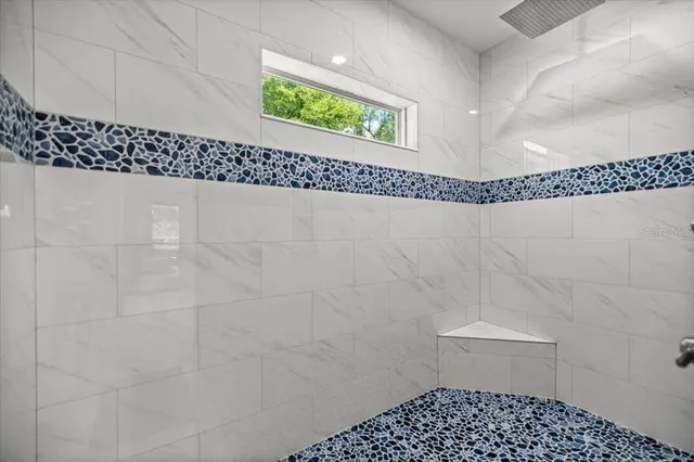 a bathroom with a sink a toilet and a shower