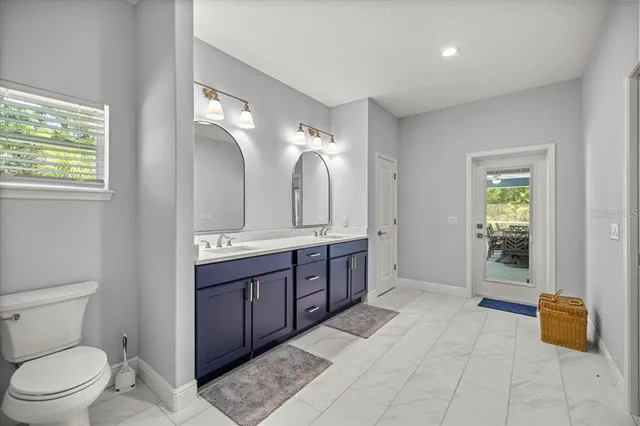 a spacious bathroom with a double vanity sink and a mirror