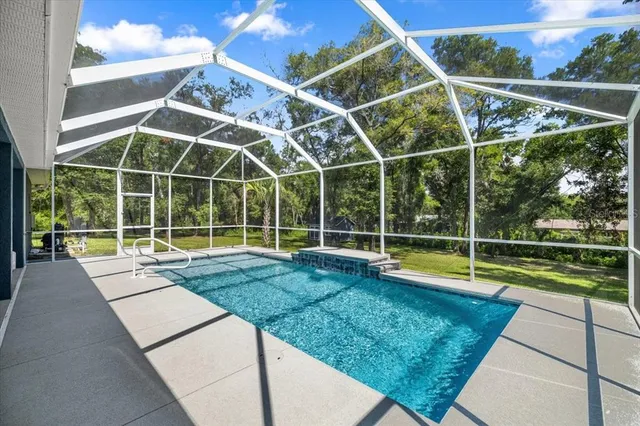 a view of a backyard with a swimming pool