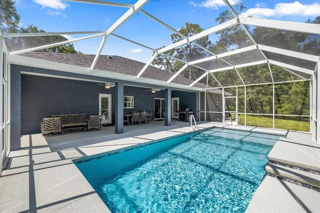 a view of a backyard with sitting area and tub