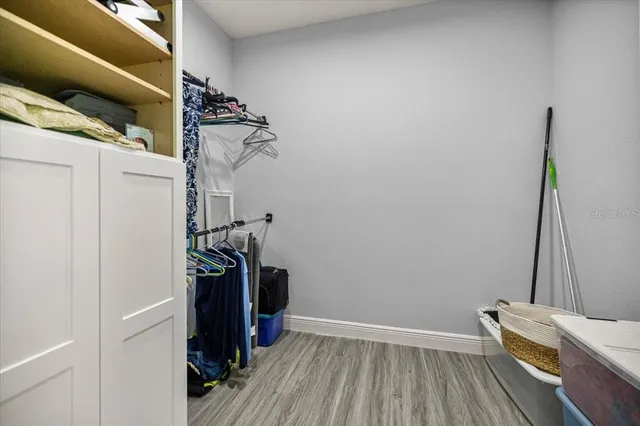a view of a room with wooden floor