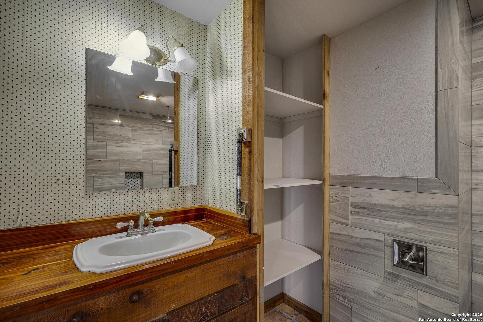 360 Kirk Lane Bulverde, TX 78163 - Photo 11 of 50 a bathroom with a sink and a mirror