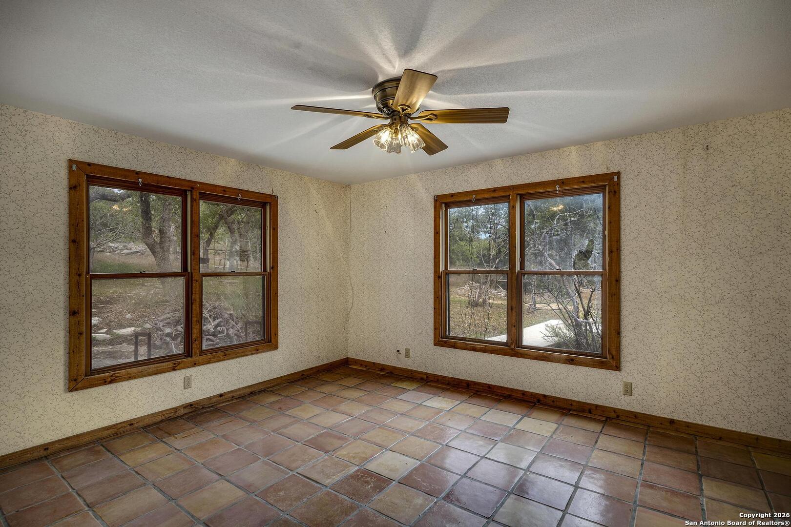 360 Kirk Lane Bulverde, TX 78163 - Photo 12 of 50 an empty room with windows and fan