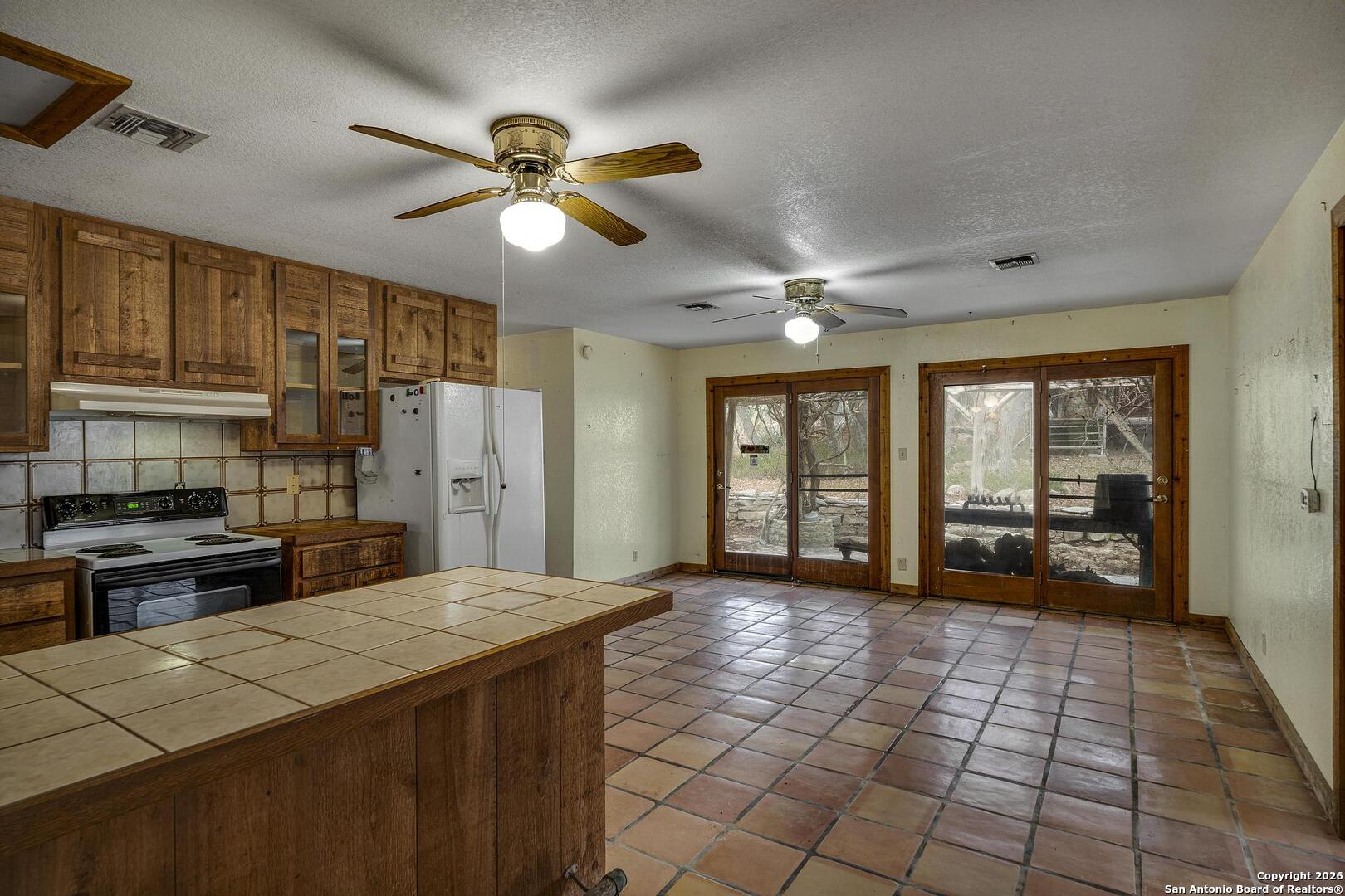 360 Kirk Lane Bulverde, TX 78163 - Photo 6 of 50 a large kitchen with sink a stove and a refrigerator