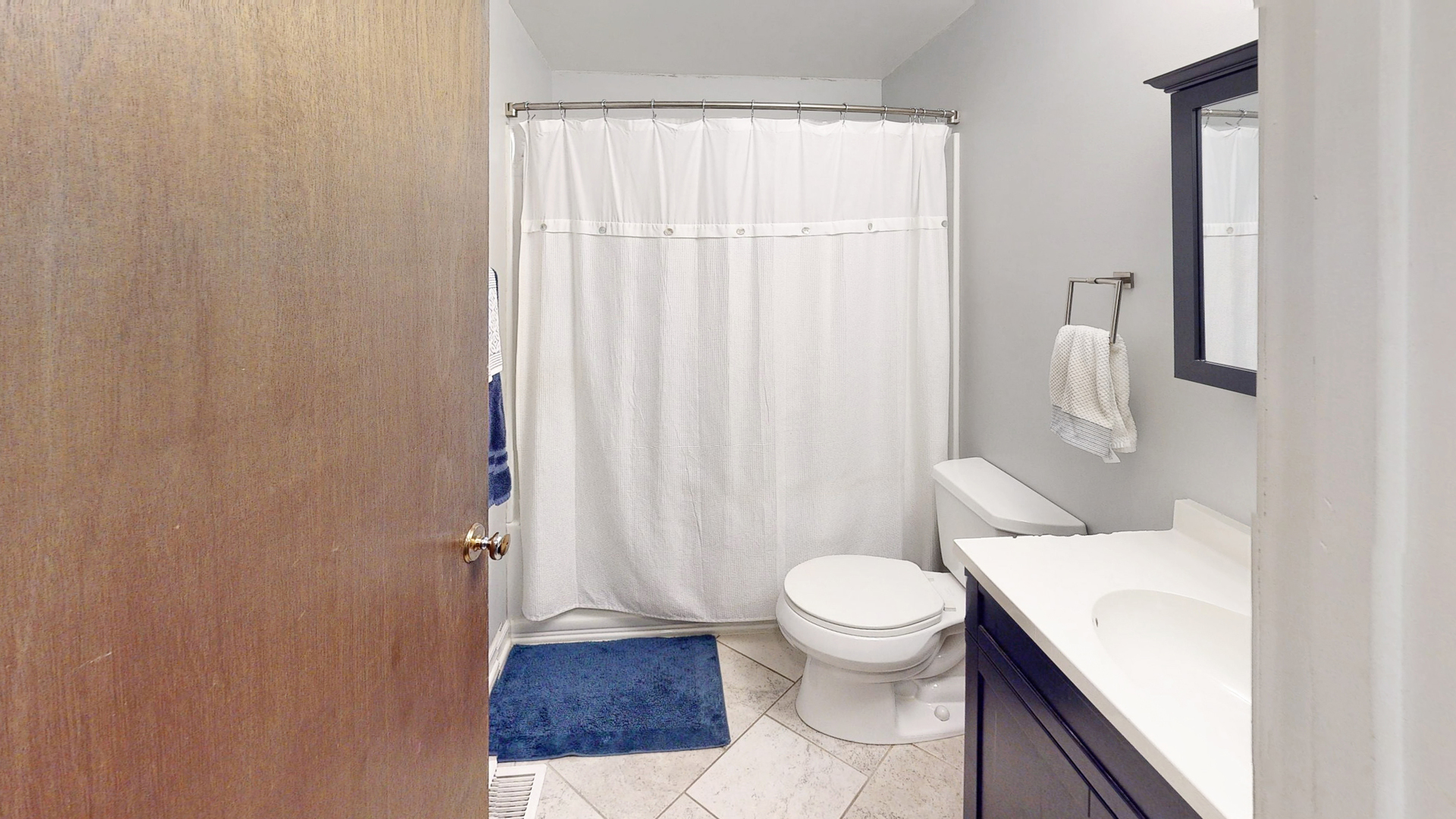 44 Aldon Road Montgomery, IL 60538 - Photo 13 of 24 a white toilet sitting next to a bathroom sink