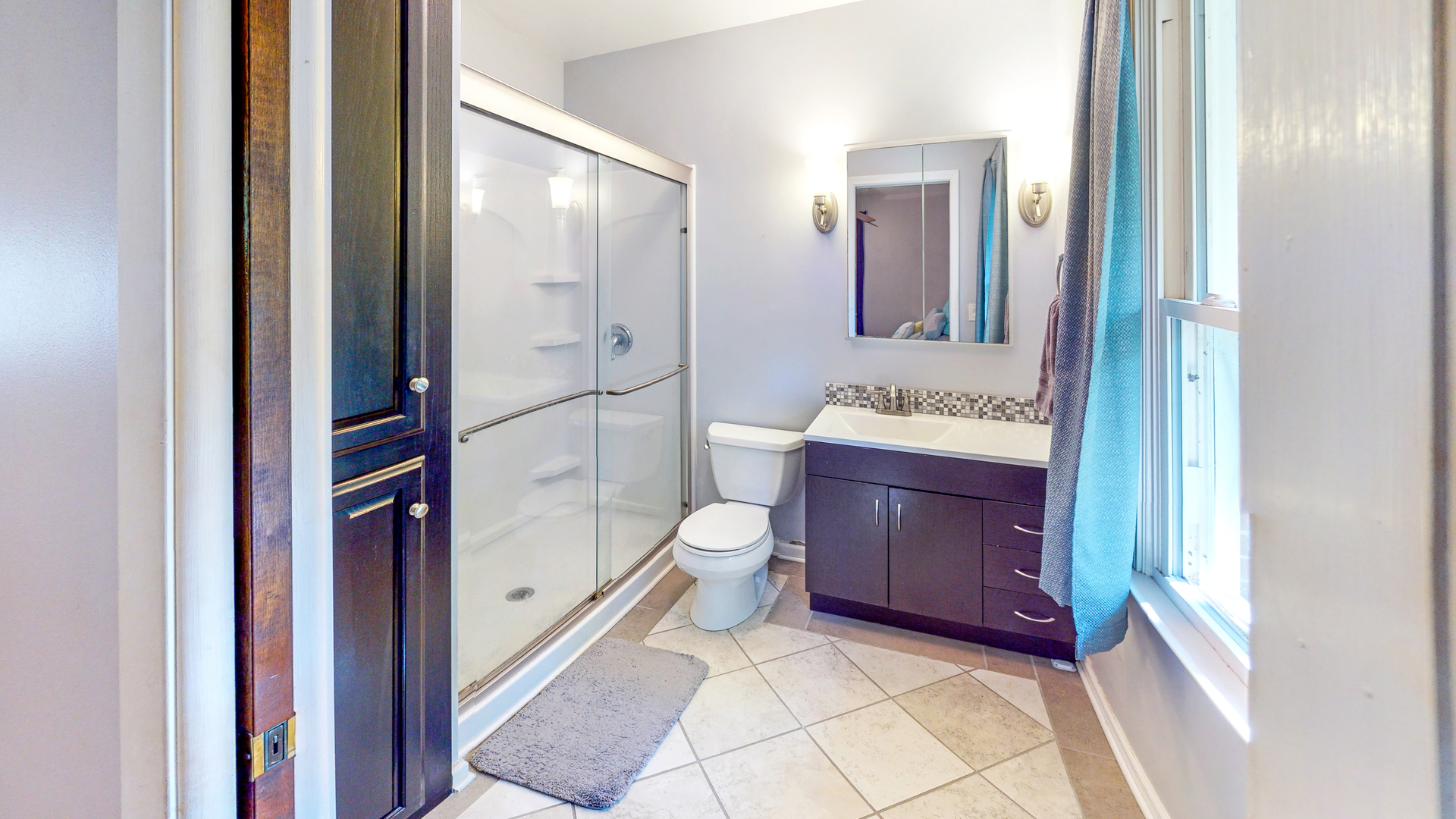 44 Aldon Road Montgomery, IL 60538 - Photo 18 of 24 a spacious bathroom with a granite countertop toilet a sink and mirror