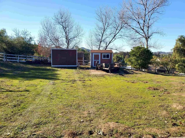 a view of pool with outdoor seating and house in the background