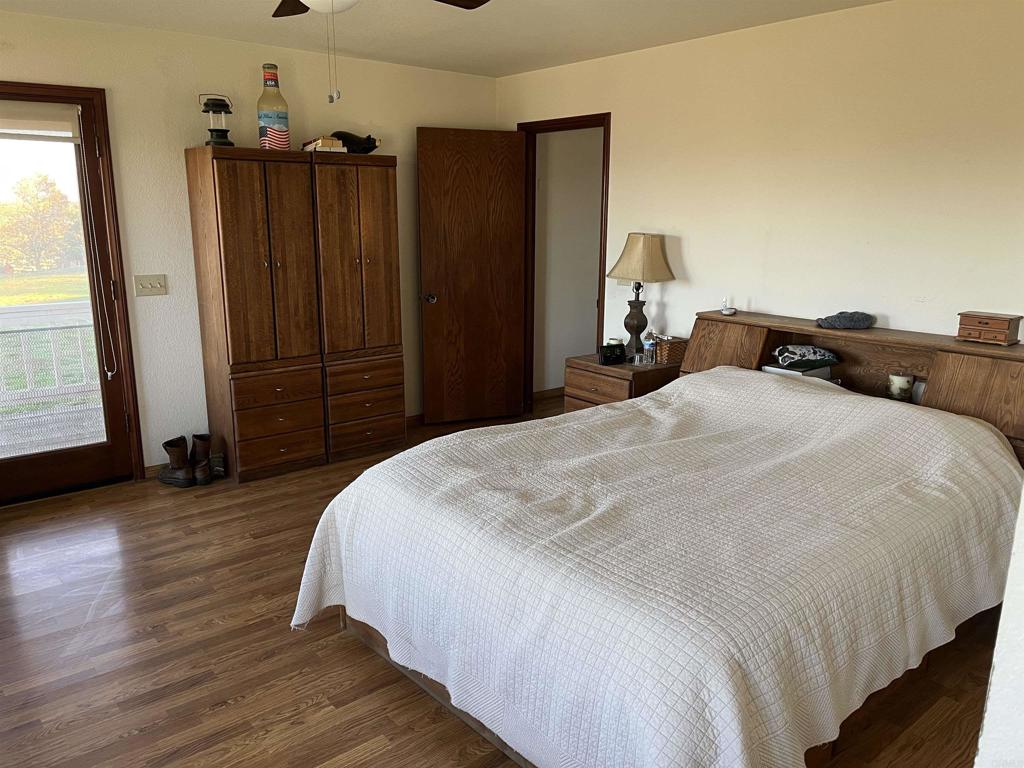 17910 Bluegrass Road Ramona, CA 92065 - Photo 26 of 33 a bedroom with a bed a dresser and wooden floor