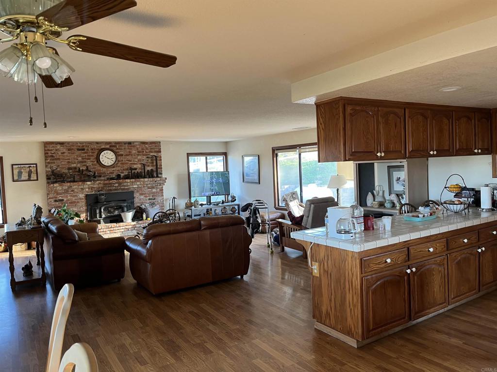 17910 Bluegrass Road Ramona, CA 92065 - Photo 31 of 33 a living room with furniture a fireplace and a large window