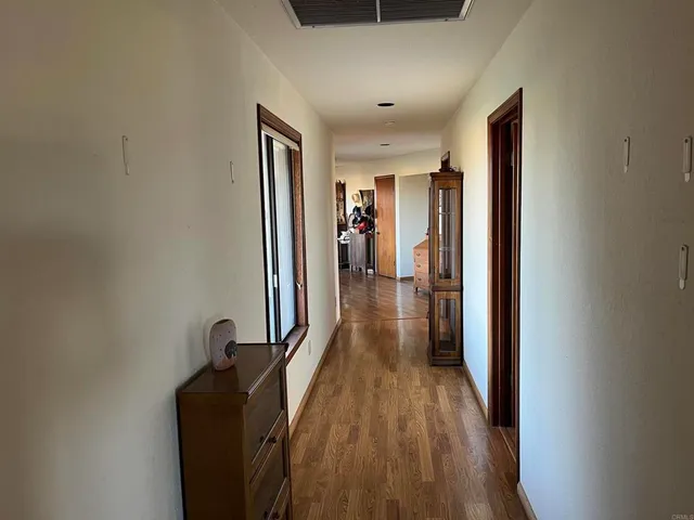 a view of a livingroom with workspace and a window