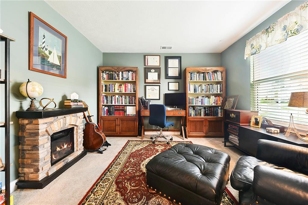 4302 Spruce Road Gibsonia, PA 15044 - Photo 21 of 24 a living room with furniture a fireplace and a window