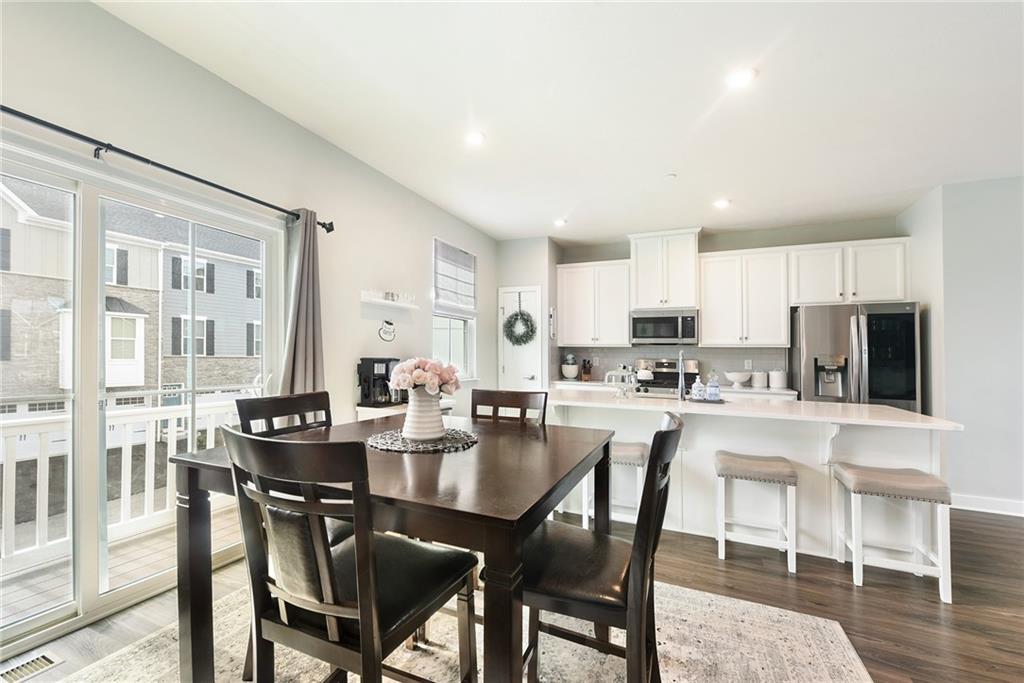 4302 Spruce Road Gibsonia, PA 15044 - Photo 7 of 24 a dining room with stainless steel appliances kitchen island granite countertop a dining table chairs and a refrigerator