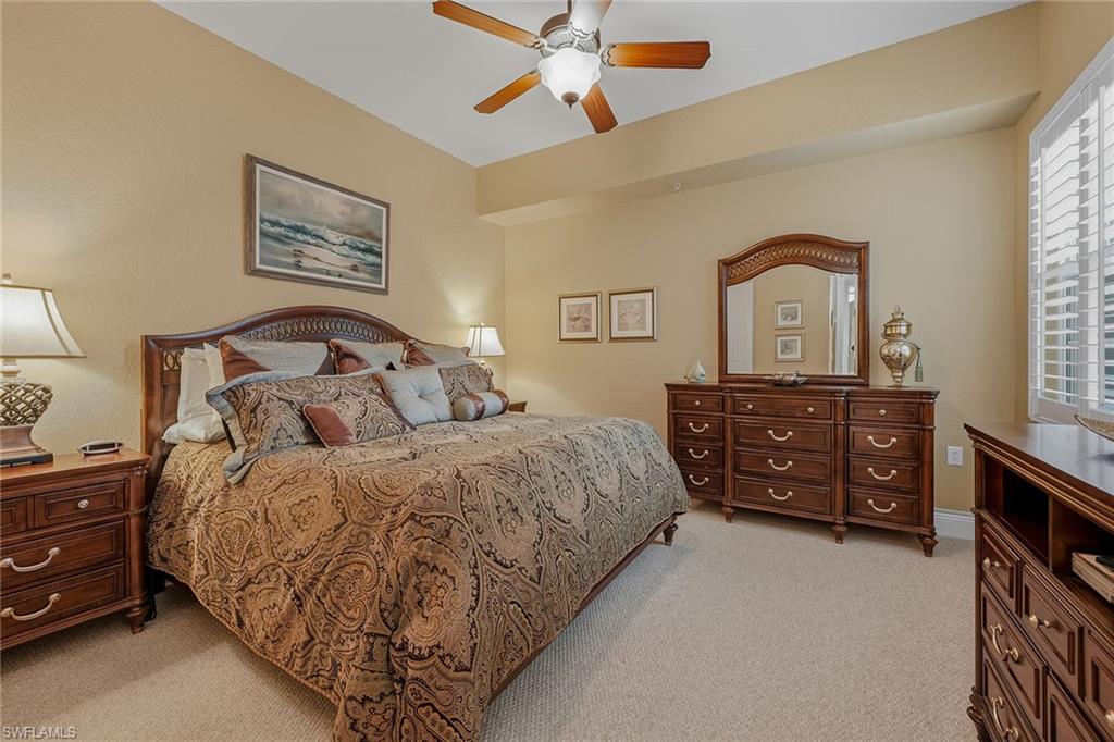 9233 Museo Circle, Unit 103 Naples, FL 34114 - Photo 14 of 49 a bedroom with a bed dresser and window