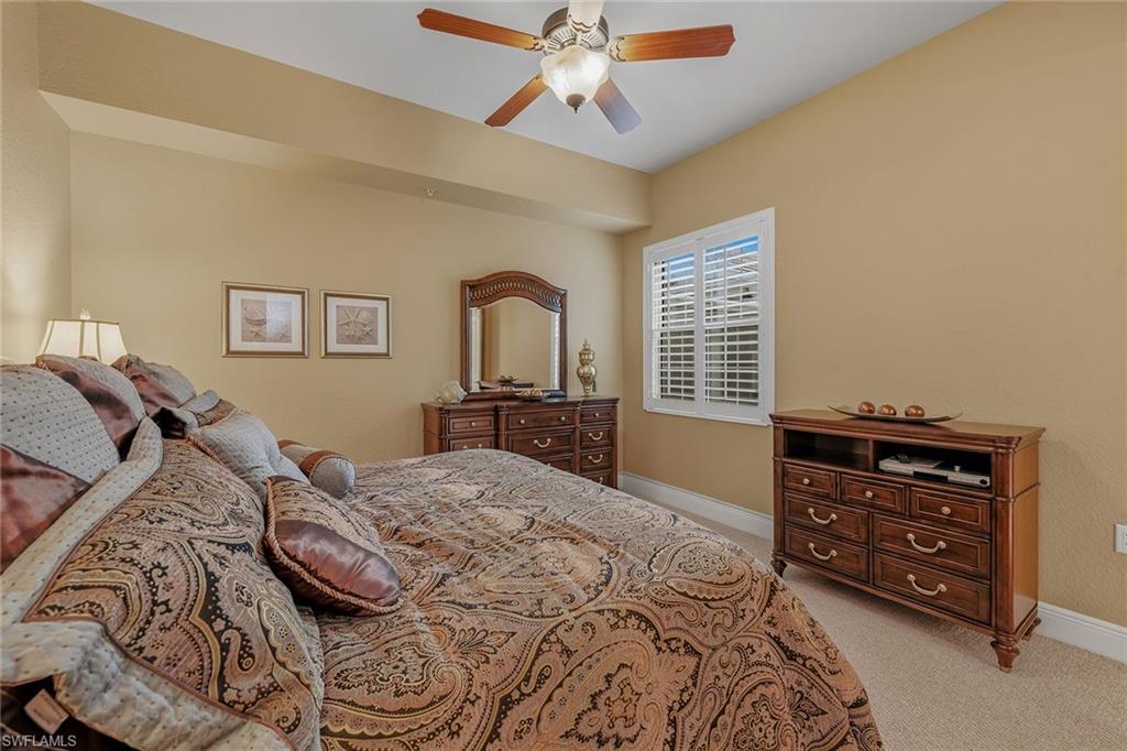 9233 Museo Circle, Unit 103 Naples, FL 34114 - Photo 15 of 49 a bedroom with a bed and a dresser