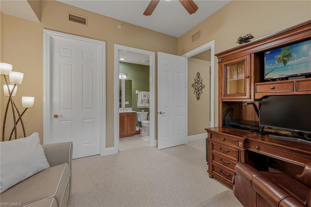 9233 Museo Circle, Unit 103 Naples, FL 34114 - Photo 18 of 49 a living room with furniture and a flat screen tv