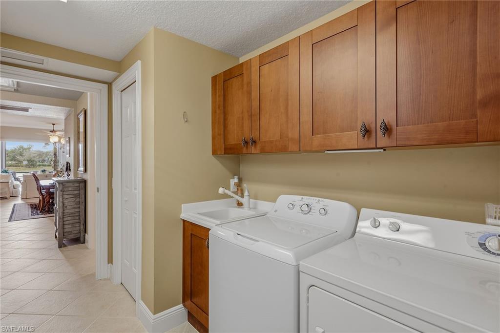 9233 Museo Circle, Unit 103 Naples, FL 34114 - Photo 20 of 49 a utility room with dryer and washer