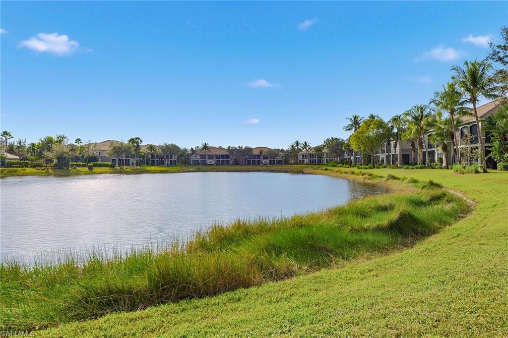 9233 Museo Circle, Unit 103 Naples, FL 34114 - Photo 25 of 49 a view of a lake with houses in the back