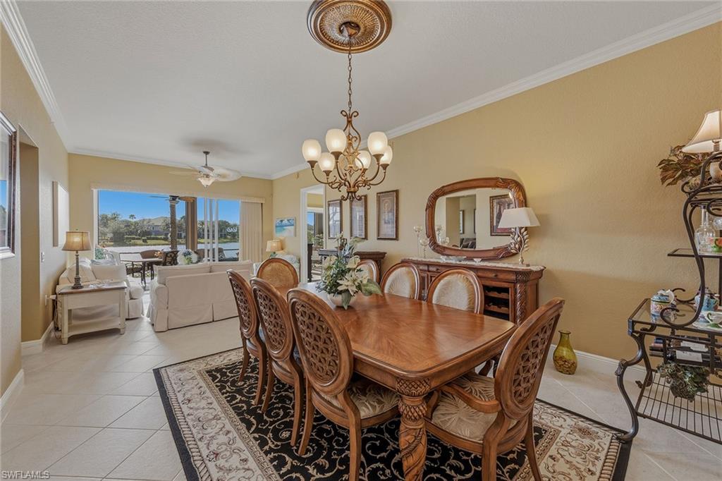 9233 Museo Circle, Unit 103 Naples, FL 34114 - Photo 9 of 49 a view of a dining room with furniture and a chandelier