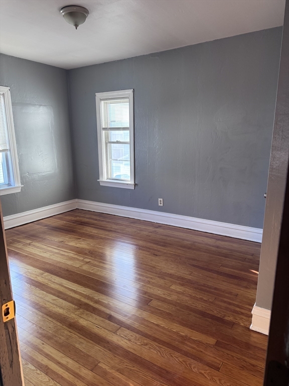 10 Choate Street, Unit 2 Fall River, MA 02723 - Photo 8 of 10 wooden floor in an empty room with a window