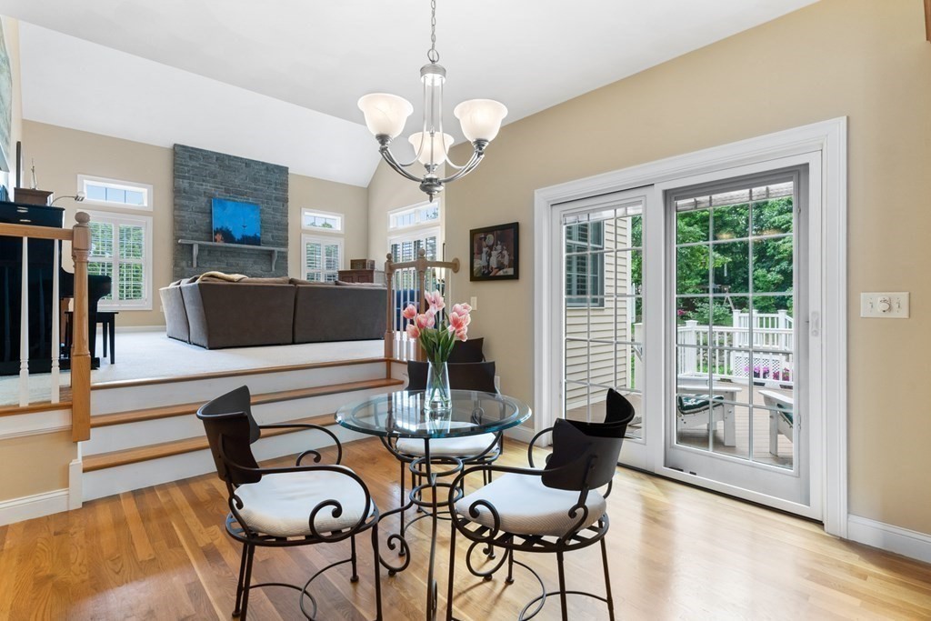 8 Boutwell Road Andover, MA 01810 - Photo 14 of 42 a living room with fireplace furniture and a chandelier