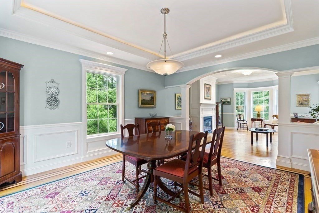 8 Boutwell Road Andover, MA 01810 - Photo 8 of 42 a dining room with furniture a chandelier and wooden floor