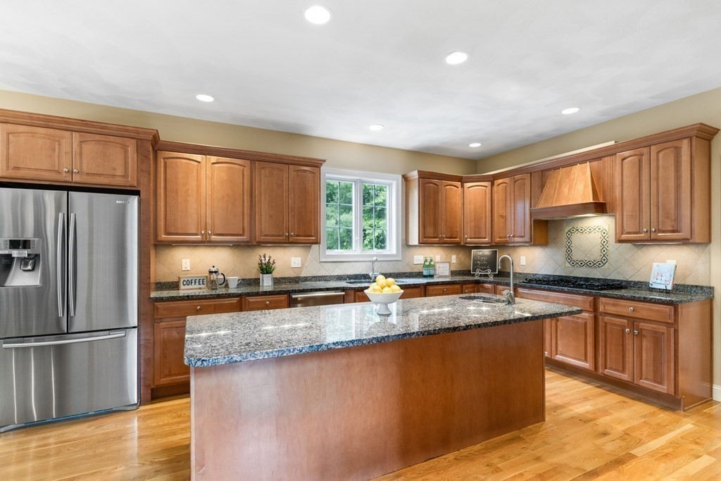8 Boutwell Road Andover, MA 01810 - Photo 10 of 42 a kitchen with stainless steel appliances granite countertop a stove a sink a refrigerator and cabinets