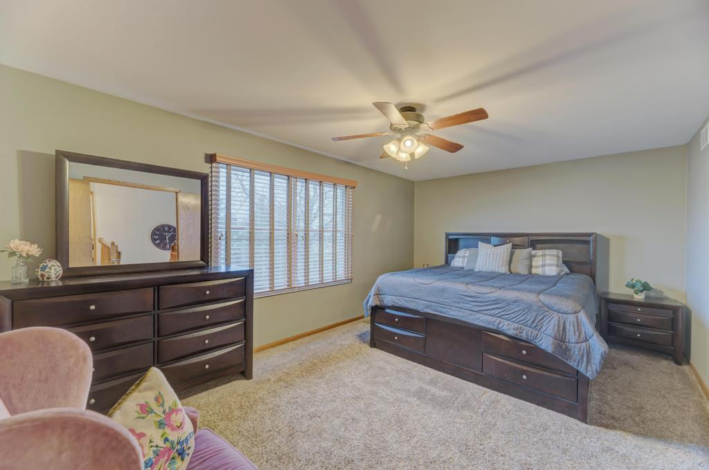 460 Springwood Lane Bolingbrook, IL 60440 - Photo 21 of 35 a bedroom with a bed and a chandelier