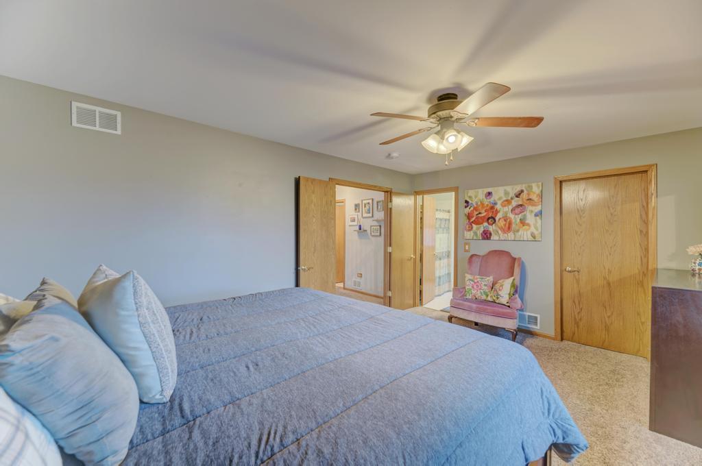 460 Springwood Lane Bolingbrook, IL 60440 - Photo 22 of 35 a bedroom with a bed and a chandelier